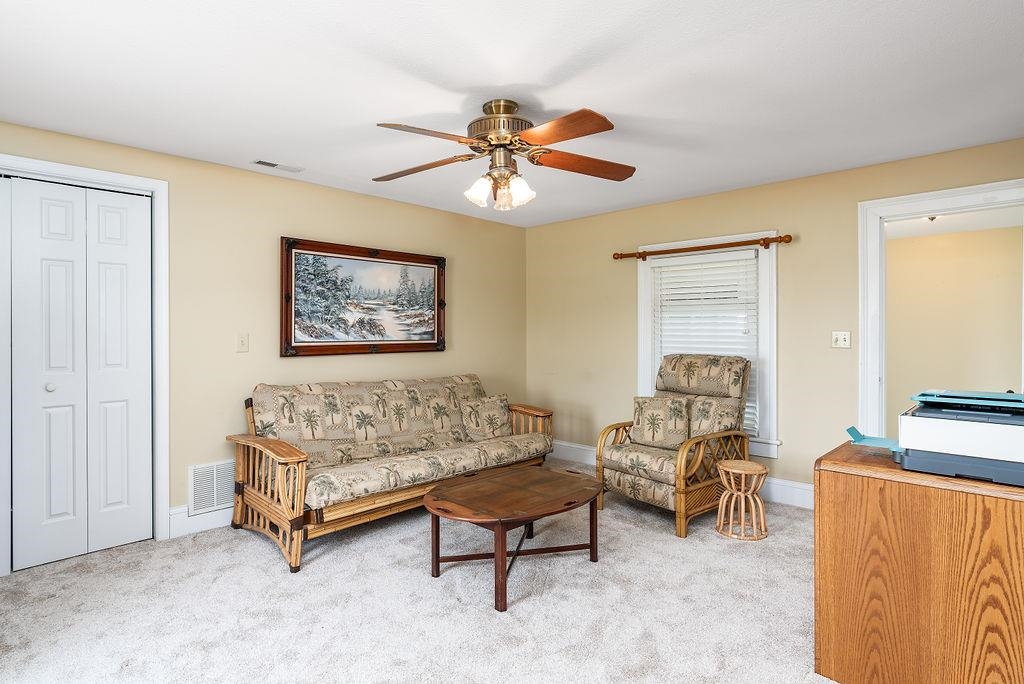 150 Ridgemore Drive Raphine, VA 24472 - Photo 47 of 75 a living room with furniture a bed and a flat screen tv