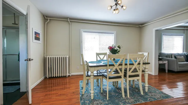 a view of a dining room with furniture wooden floor and chandelier