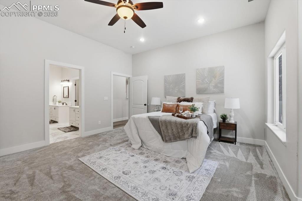 15755 Fool's Gold Lane Colorado Springs, CO 80921 - Photo 18 of 50 a bedroom with a large bed and ceiling fan