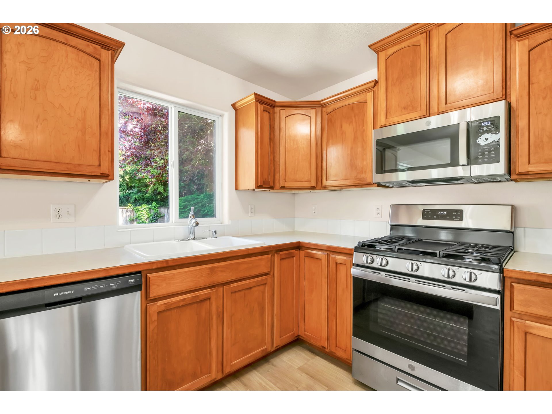 585 Dublin Avenue Eugene, OR 97404 - Photo 12 of 32 a kitchen with stainless steel appliances granite countertop a stove a sink and a microwave
