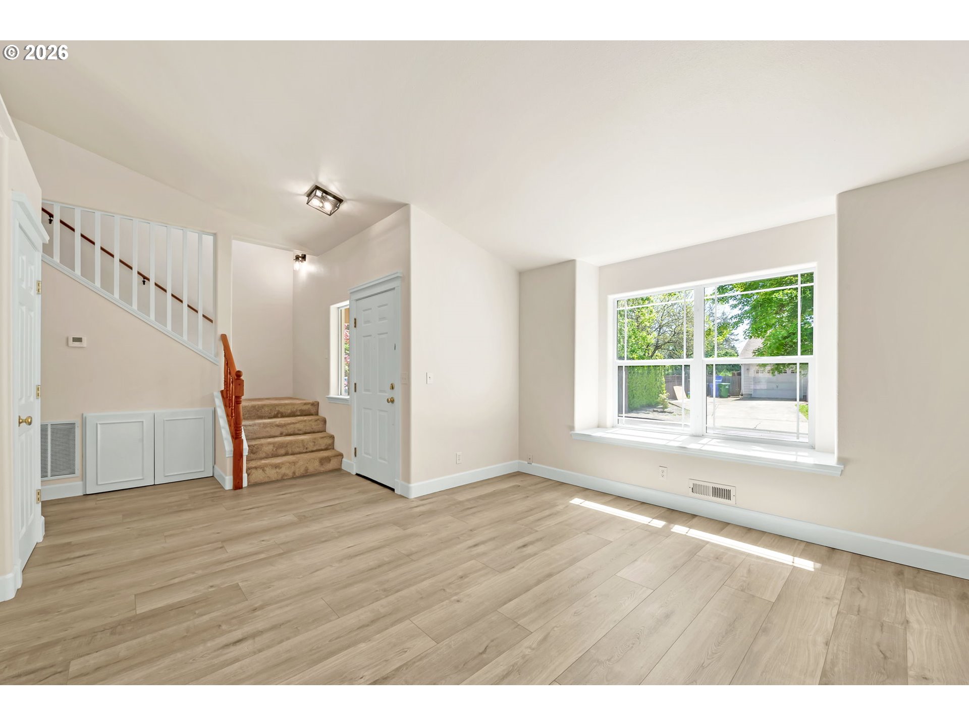 585 Dublin Avenue Eugene, OR 97404 - Photo 4 of 32 a view of an empty room with wooden floor and stairs