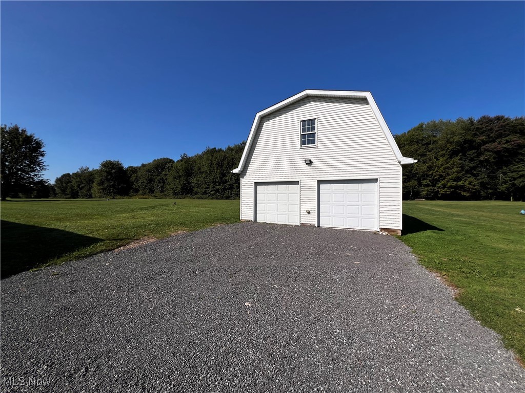 6949 Fee Road Rome, OH 44085 - Photo 2 of 19 Garage featuring a yard