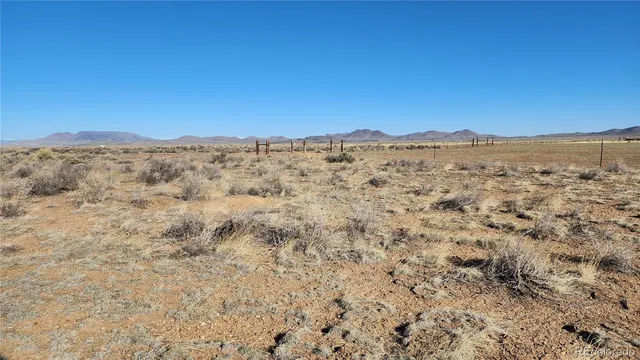 a view of a mountain range with trees in the background