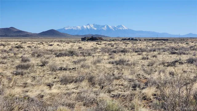 a view of mountain with sunset in background