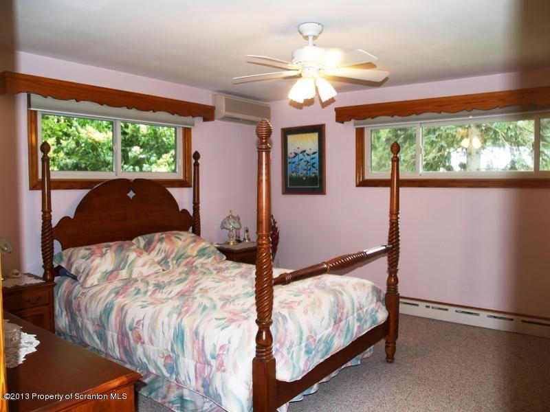 1221 Mt Cobb Road Lake Ariel, PA 18436 - Photo 9 of 29 a bed sitting in a bedroom next to a window