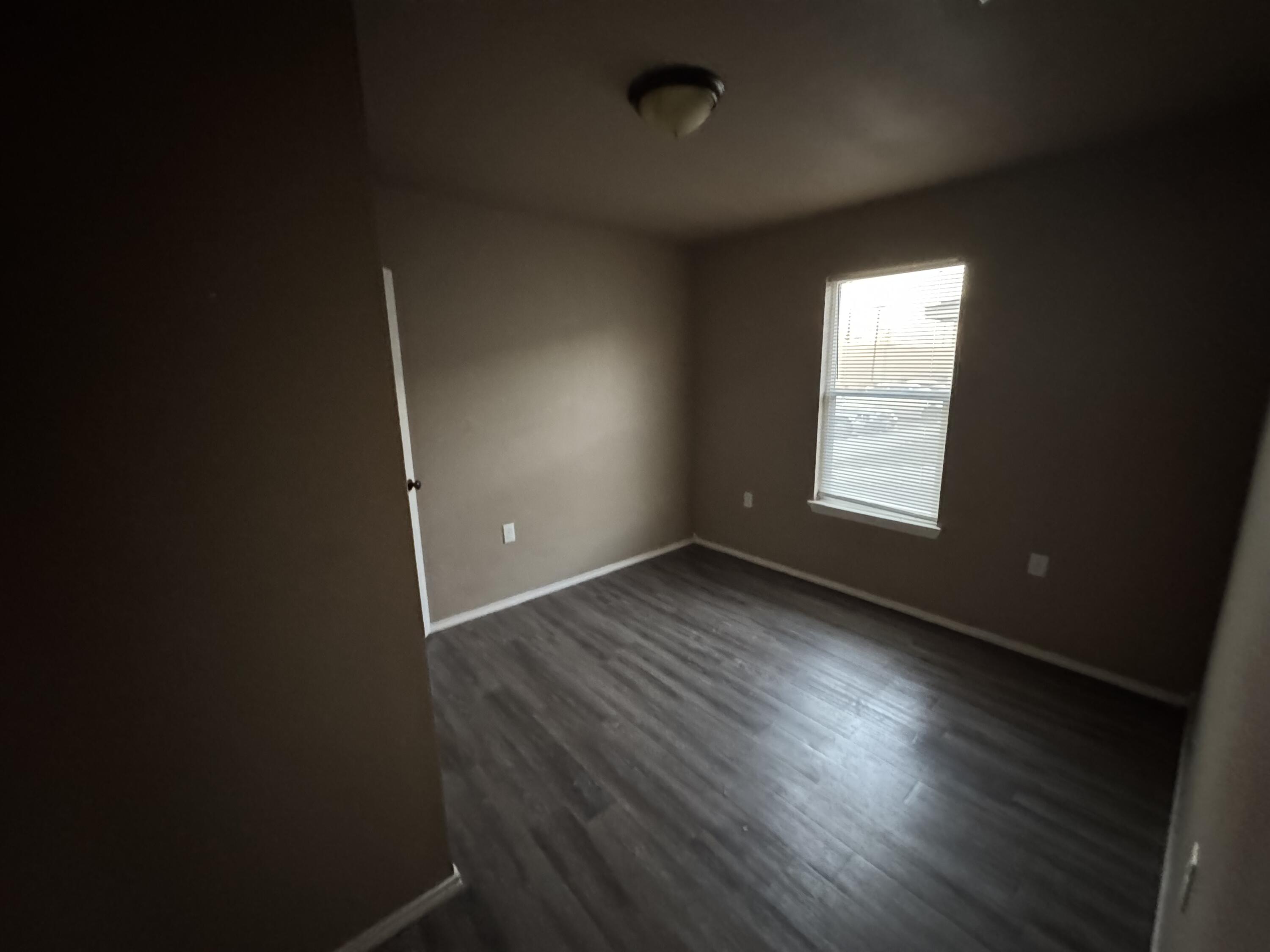 301 36th Street, Unit A & B Lubbock, TX 79404 - Photo 5 of 6 an empty room with wooden floor and windows