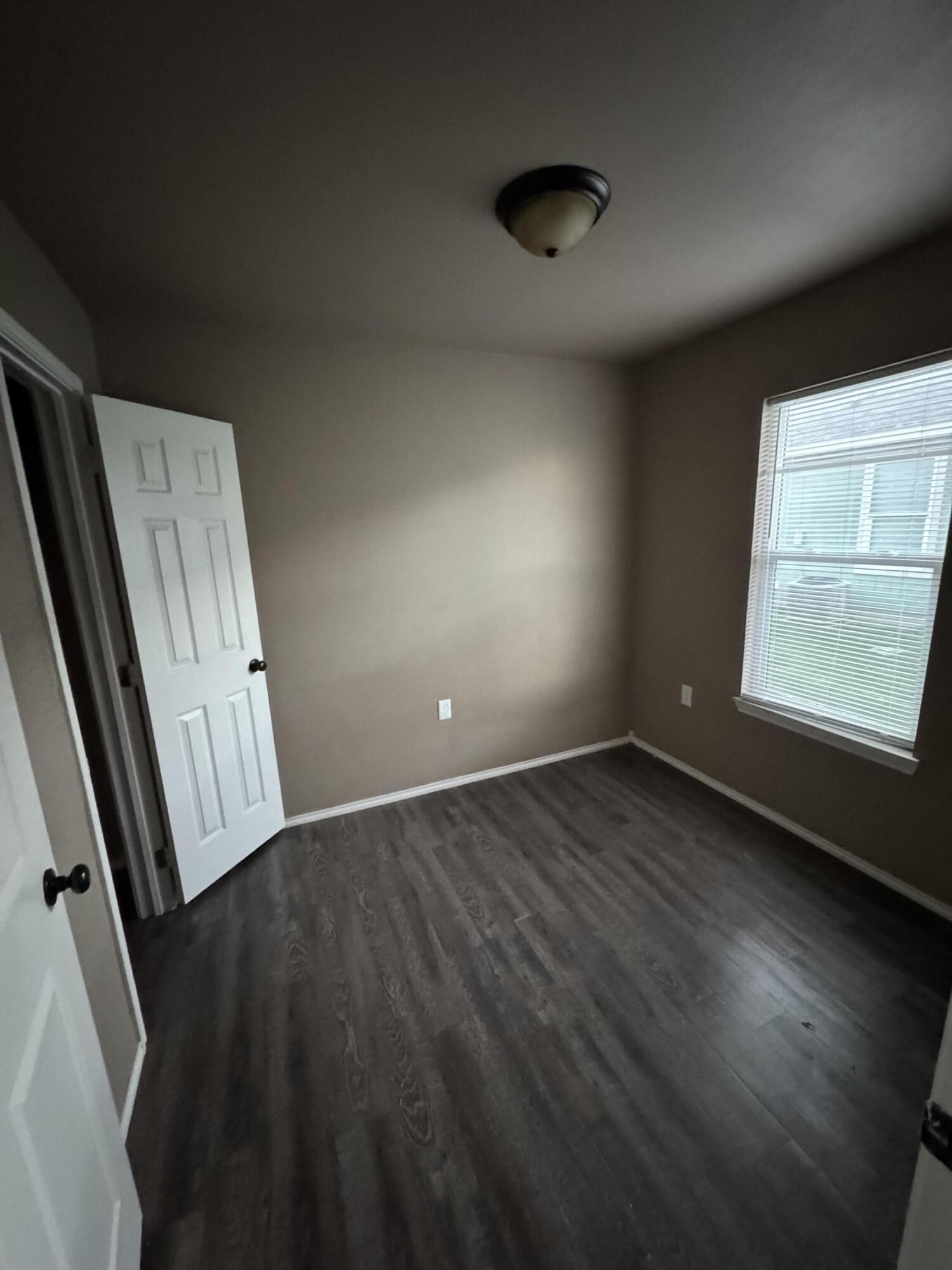 301 36th Street, Unit A & B Lubbock, TX 79404 - Photo 6 of 6 an empty room with wooden floor and windows