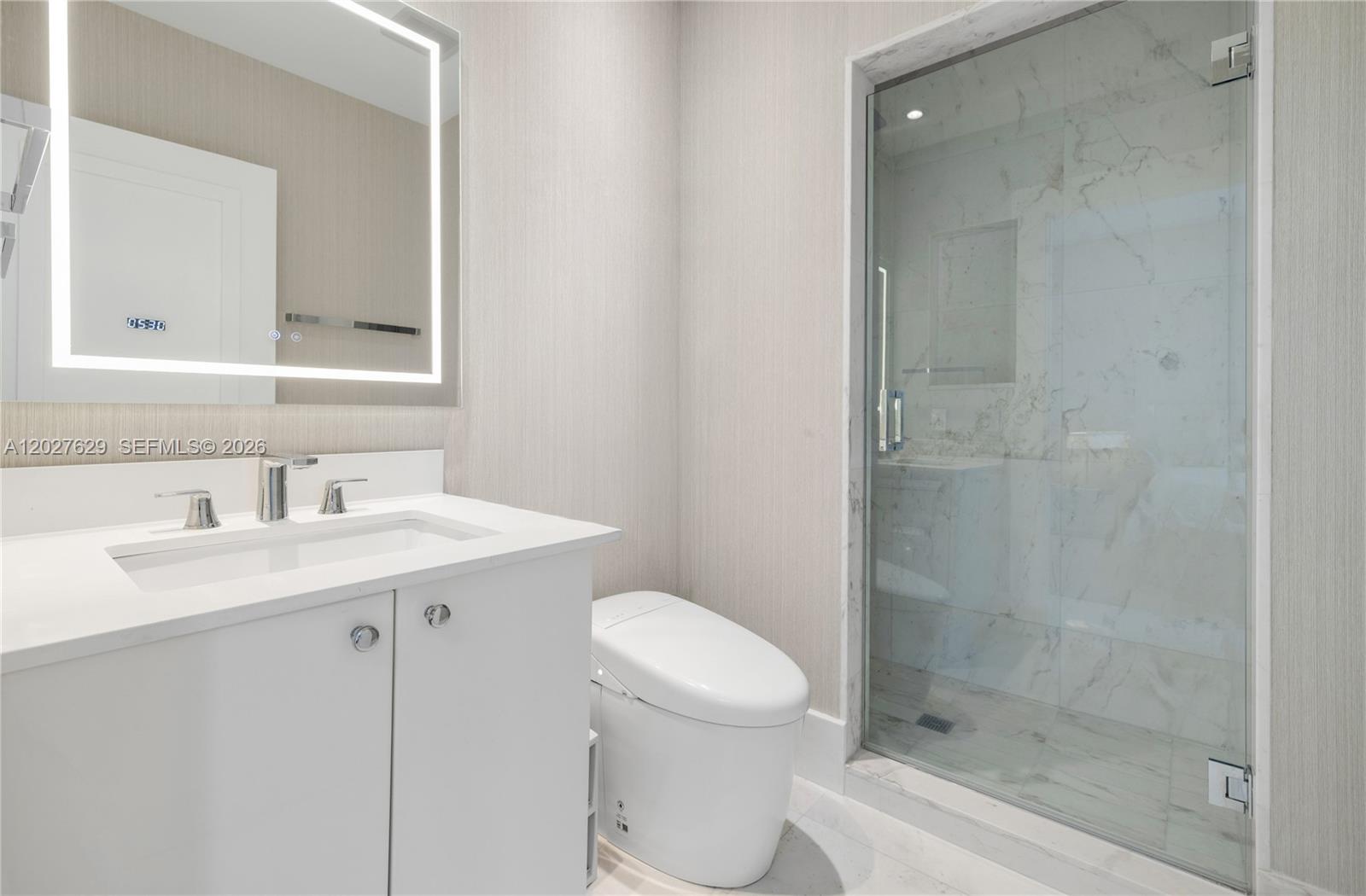 799 Crandon Boulevard, Unit PH8 Key Biscayne, FL 33149 - Photo 17 of 47 a bathroom with a sink a toilet and shower