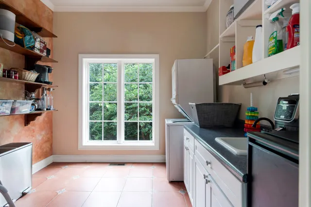 a kitchen with stainless steel appliances a sink a stove and a refrigerator