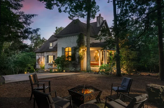 a view of patio with table and chairs and potted plants
