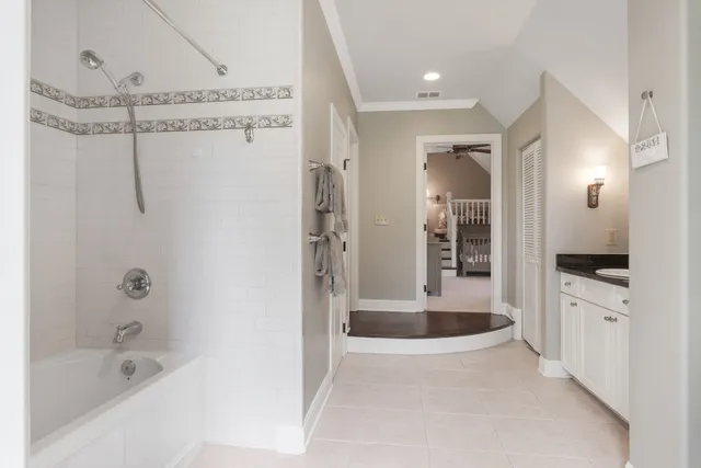 a bathroom with a bathtub a mirror a shower a sink and view