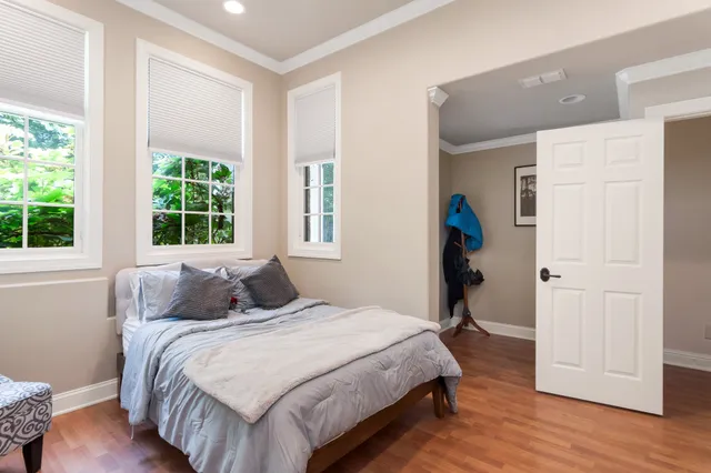 a bedroom with a bed and wooden floor