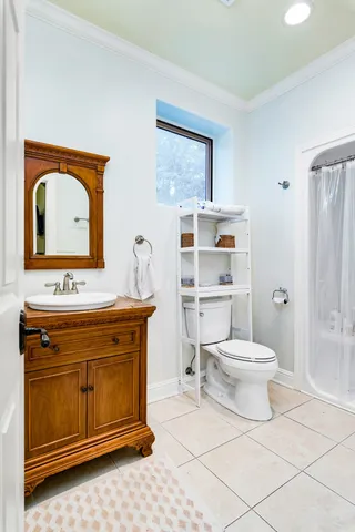 a bathroom with a toilet a sink and a mirror