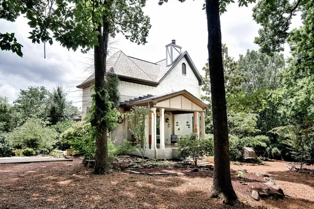 a view of a house with a tree in the background