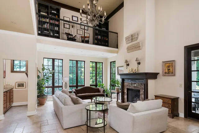 a living room with furniture a fireplace and a large window