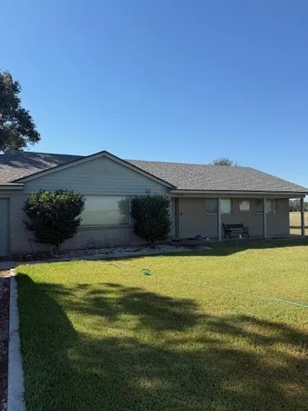 a view of a house with a swimming pool with a yard