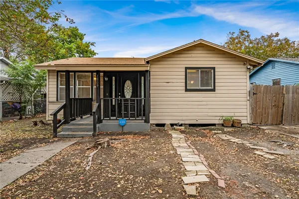 a front view of a house with a garden