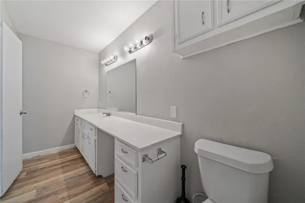 a bathroom with a sink a toilet and vanity