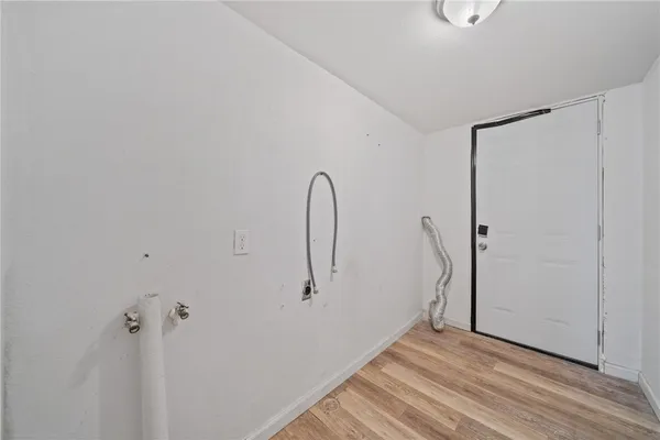 a view of a room with wooden floor and a ceiling fan