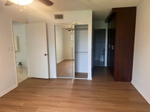a view of empty room with wooden floor