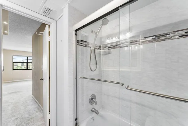 a bathroom with a glass shower door