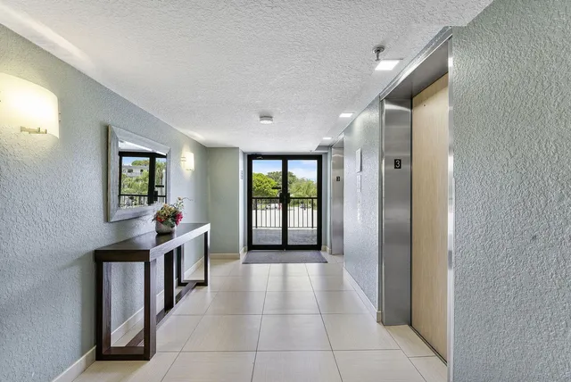 a hallway with a large window and natural light
