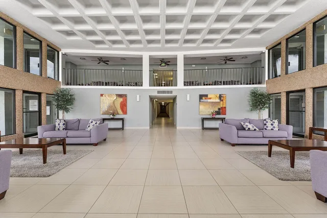 a living room with furniture and a potted plant