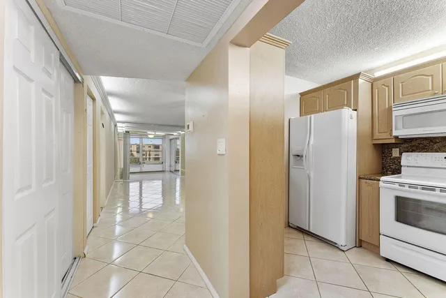 a kitchen with stainless steel appliances a refrigerator and a stove top oven