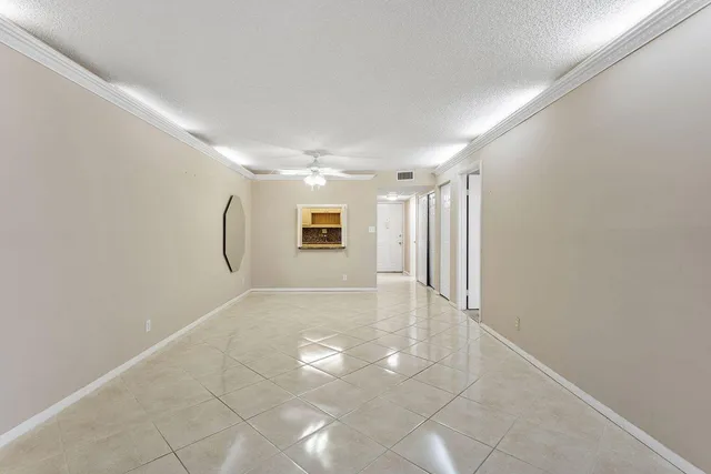 a view of a livingroom with wooden floor and a ceiling fan