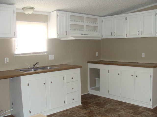 127 Morris Road Gray, GA 31032 - Photo 3 of 15 a kitchen with granite countertop white cabinets and window