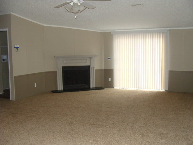 127 Morris Road Gray, GA 31032 - Photo 4 of 15 a view of an empty room with a fireplace and a window