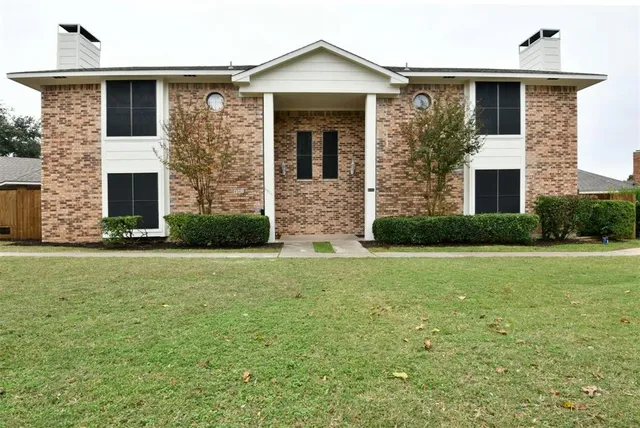 a front view of house with yard and outdoor seating