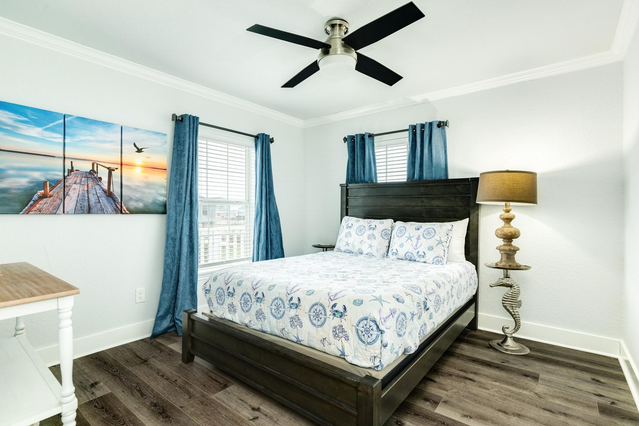 307 Angel Wing Street Surfside Beach, TX 77541 - Photo 10 of 23 a bedroom with a bed and wooden floor