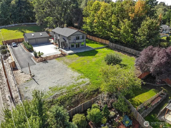 an aerial view of a house with swimming pool garden and patio