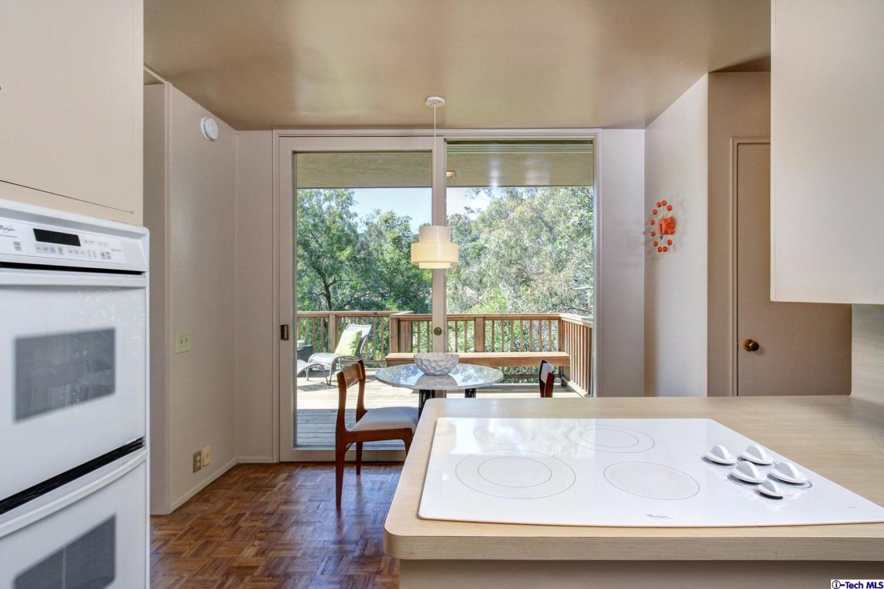 1280 Glen Oaks Boulevard Pasadena, CA 91105 - Photo 17 of 38 a living room with large window and a table