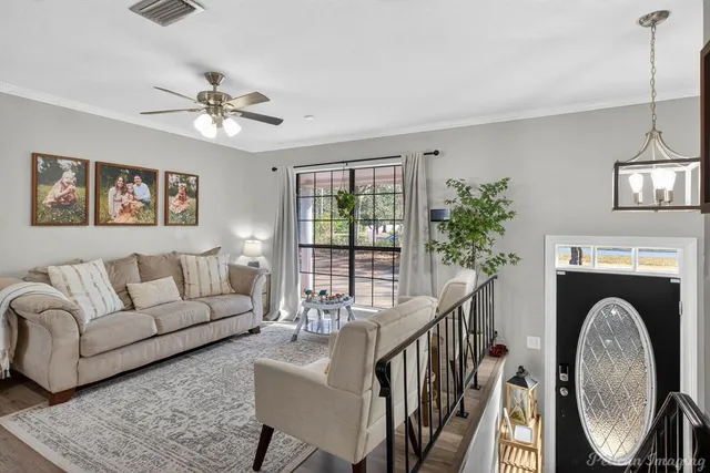 a living room with furniture a fireplace and a chandelier