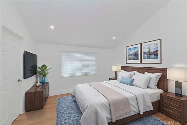 a bedroom with a bed and a flat screen tv