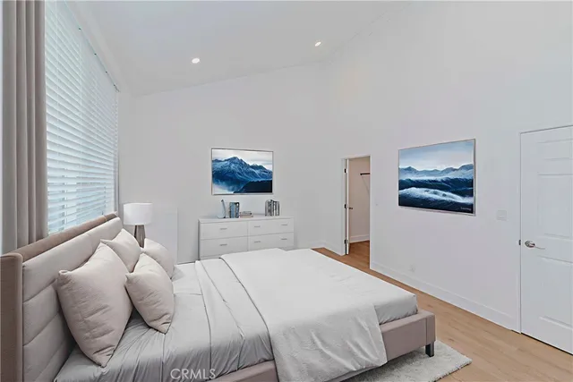 a bedroom with a bed and a painting on the wall