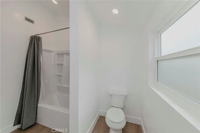 a white toilet sitting next to a bathroom sink