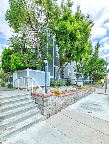 a view of a chair and table on the side of the house