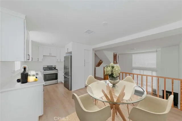 a dining room with furniture and wooden floor