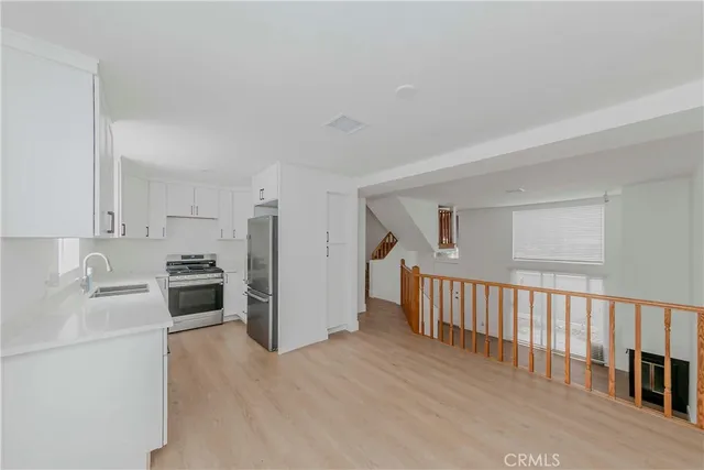 a kitchen with cabinets and stainless steel appliances