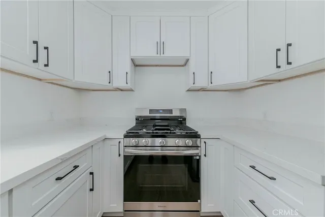 a stove top oven sitting inside of a kitchen