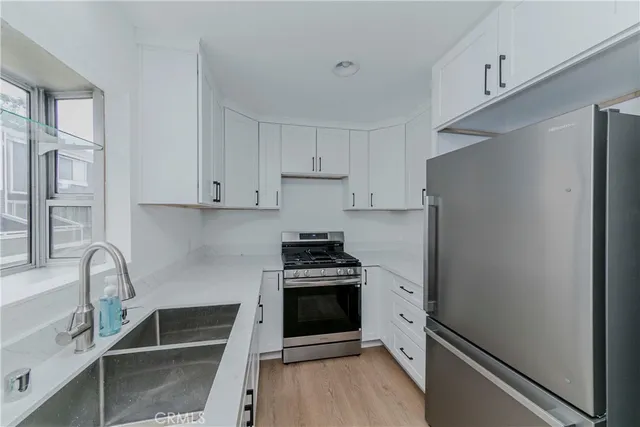 a kitchen with a stove and a refrigerator