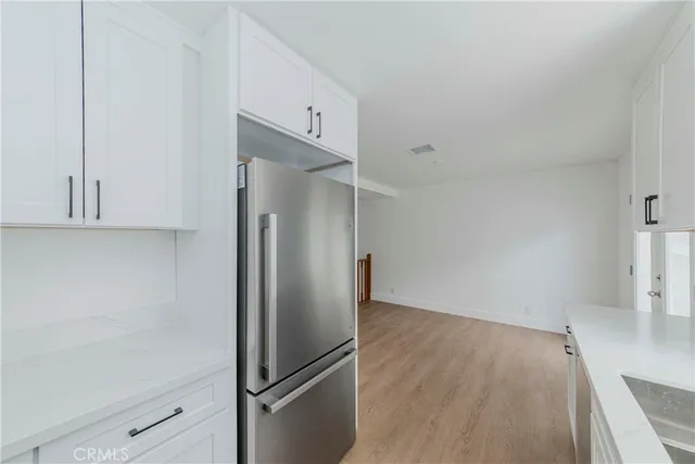 a view of a refrigerator in kitchen and cabinetry