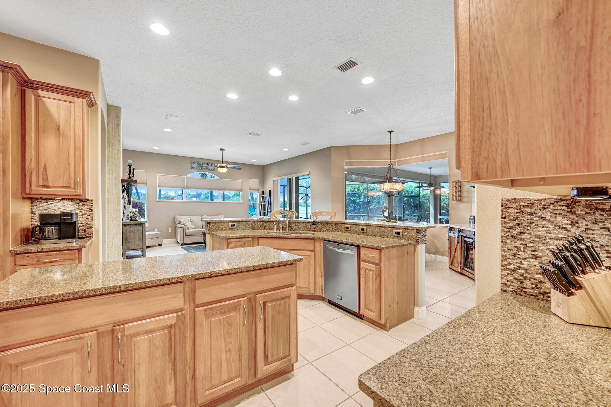 8082 Old Tramway Drive Melbourne, FL 32940 - Photo 23 of 82 a kitchen with stainless steel appliances granite countertop a stove a sink and a microwave