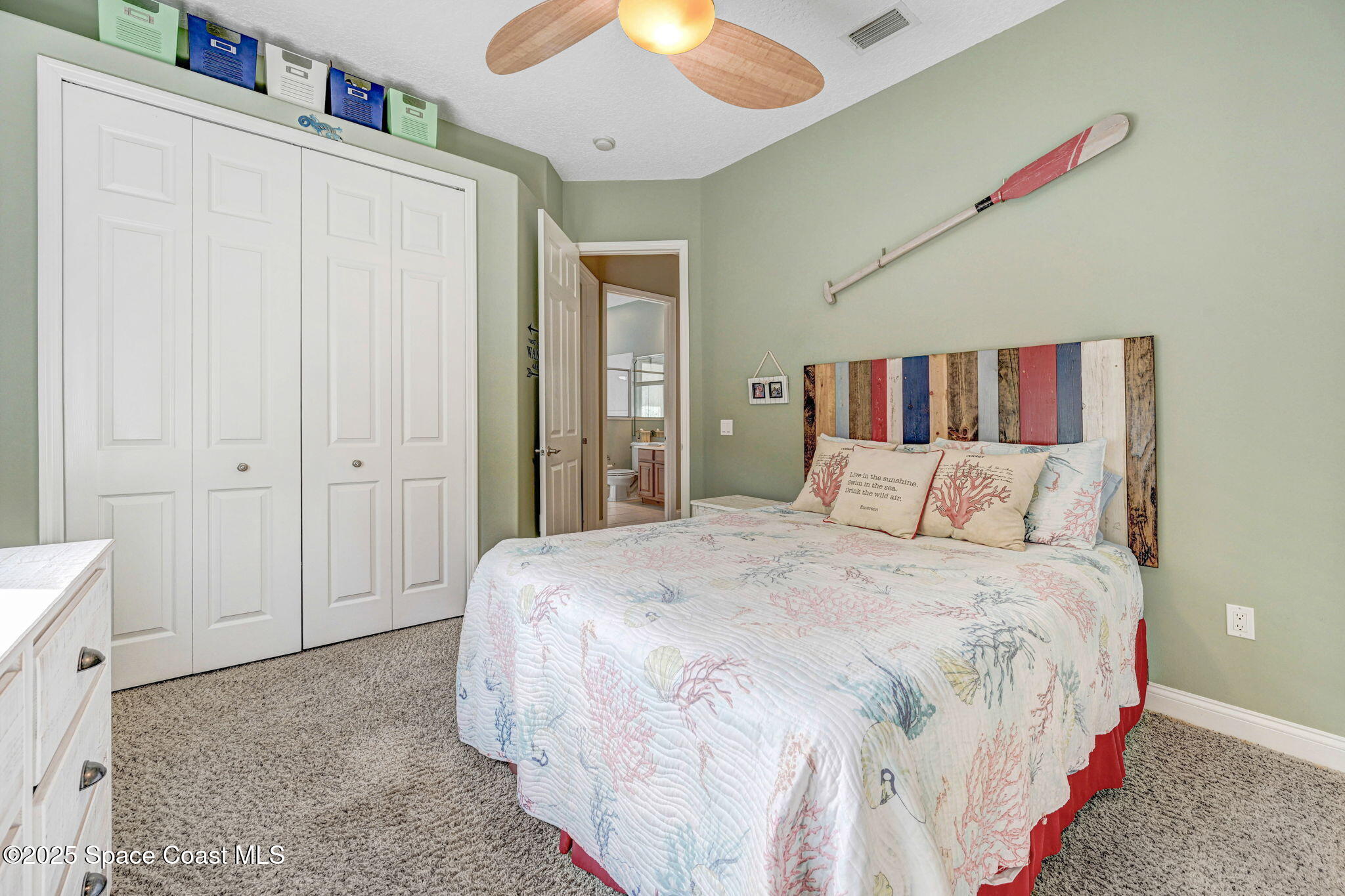8082 Old Tramway Drive Melbourne, FL 32940 - Photo 39 of 82 a bedroom with a large bed and a chandelier