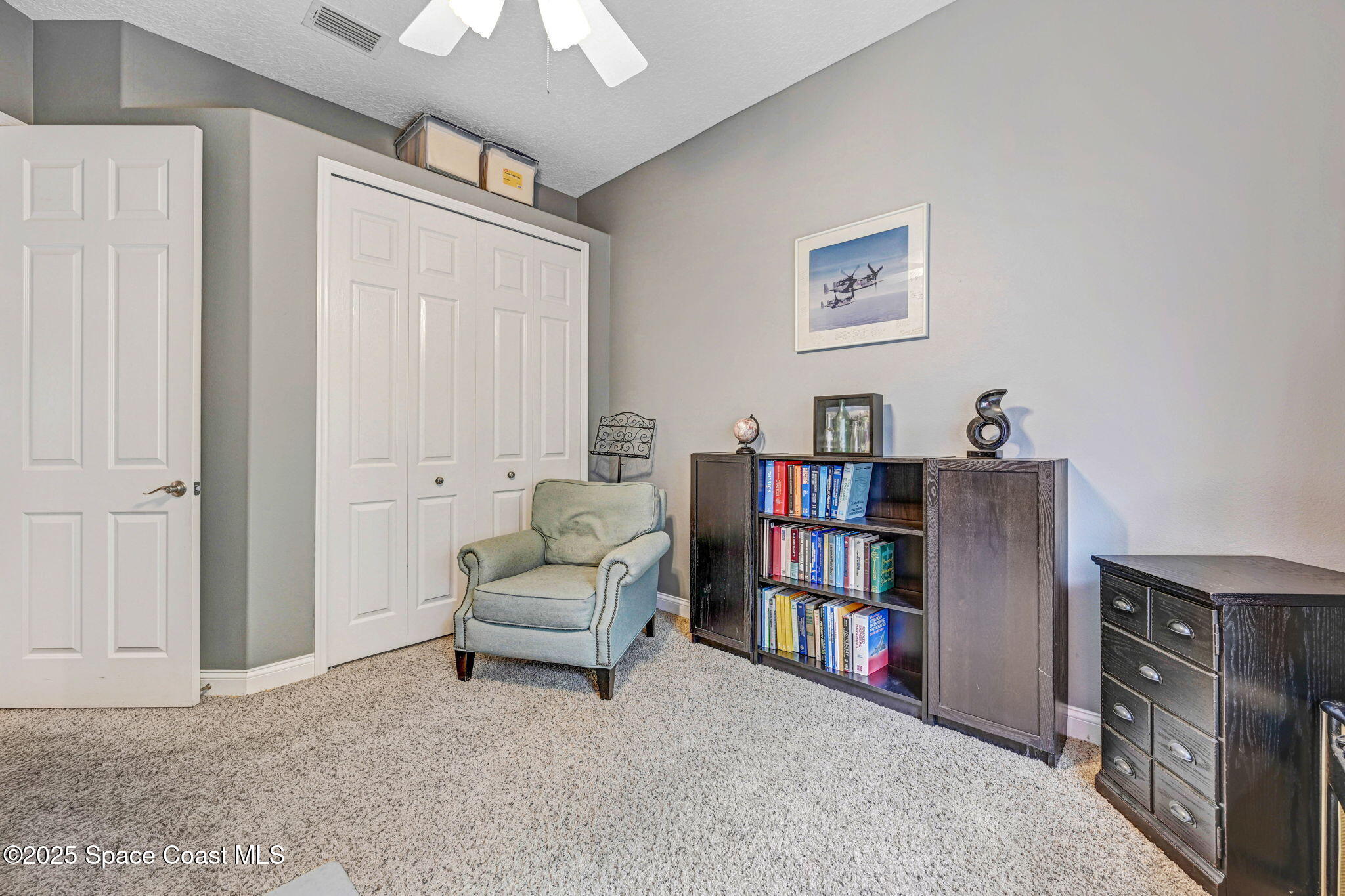 8082 Old Tramway Drive Melbourne, FL 32940 - Photo 42 of 82 a living room with furniture cabinets and a book shelf