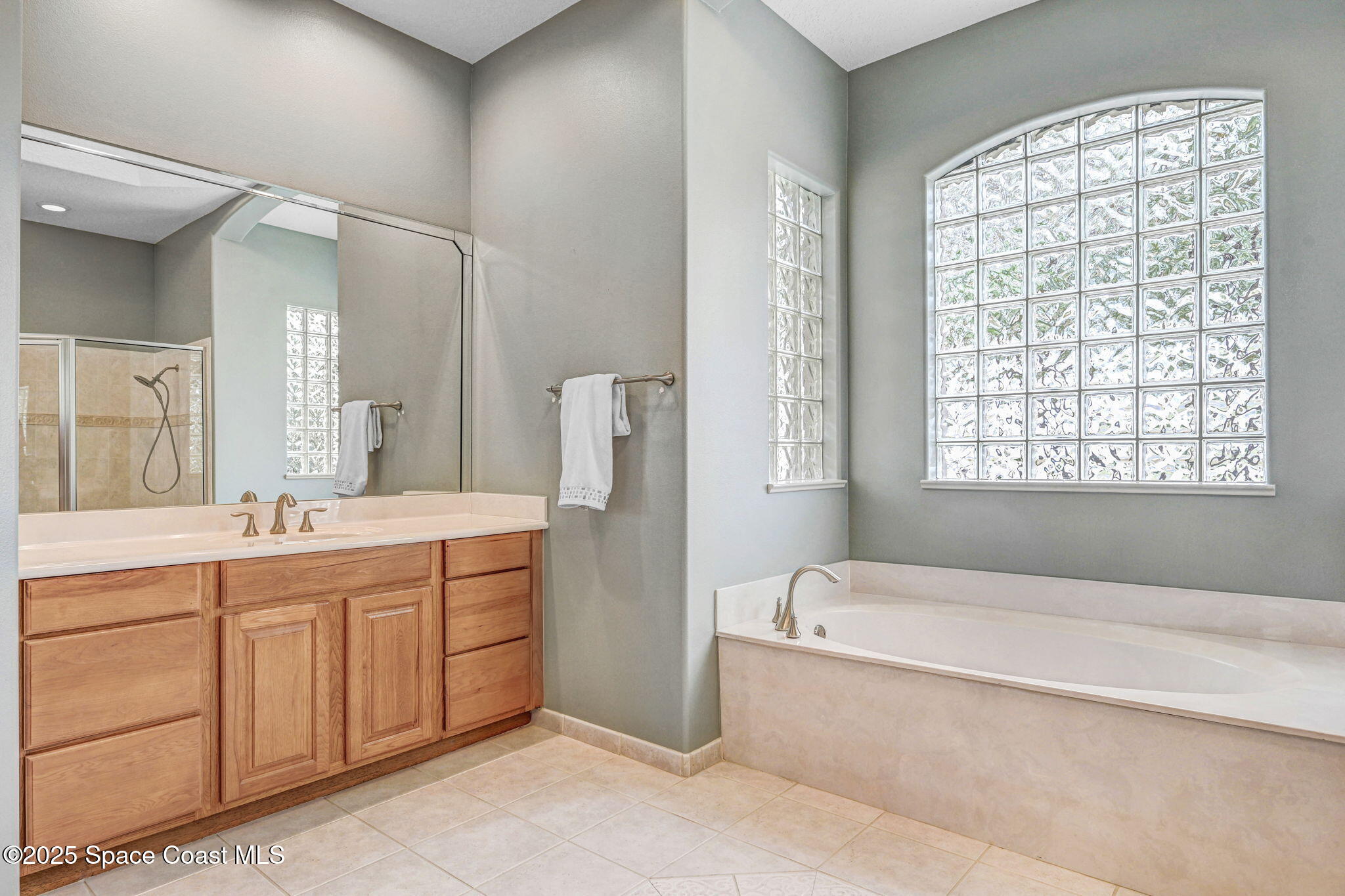 8082 Old Tramway Drive Melbourne, FL 32940 - Photo 52 of 82 a spacious bathroom with a tub sink and mirror