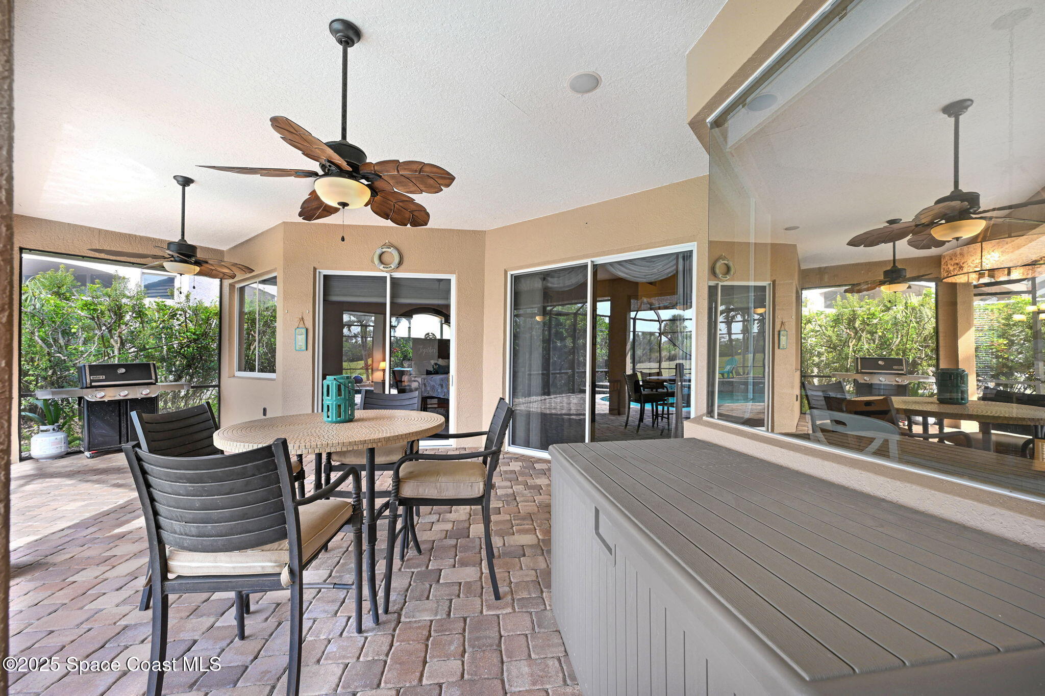 8082 Old Tramway Drive Melbourne, FL 32940 - Photo 55 of 82 a view of a dining room and livingroom with furniture wooden floor a chandelier